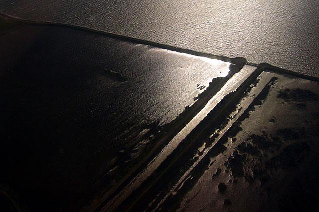 A man-made channel cuts through the Bay made, barely separating land and water.